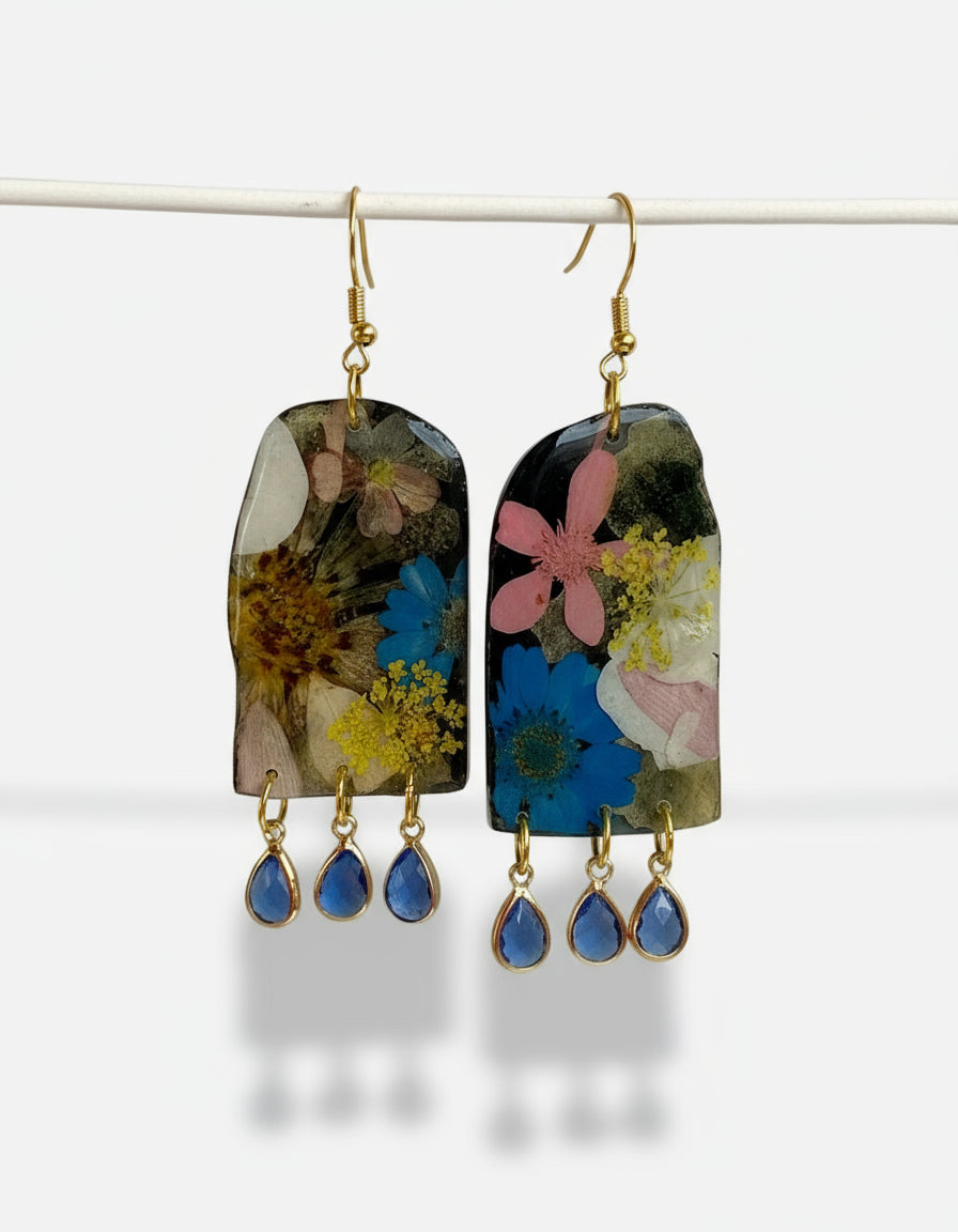 Earrings with floral design and blue teardrop pendants