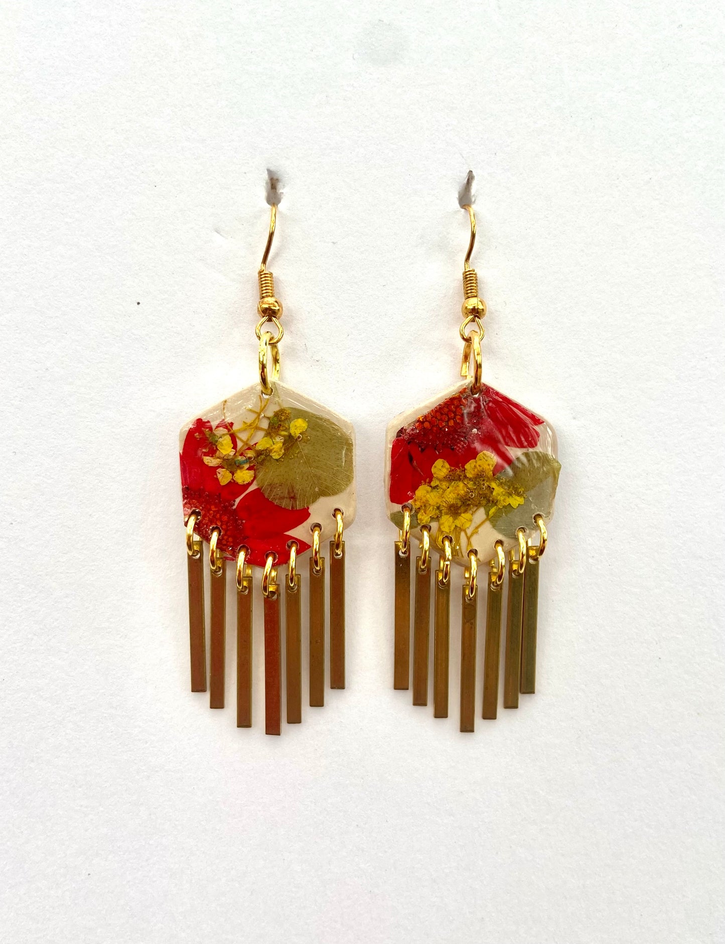 Hexagon floral polymer clay with brass fringe dangle hardware.