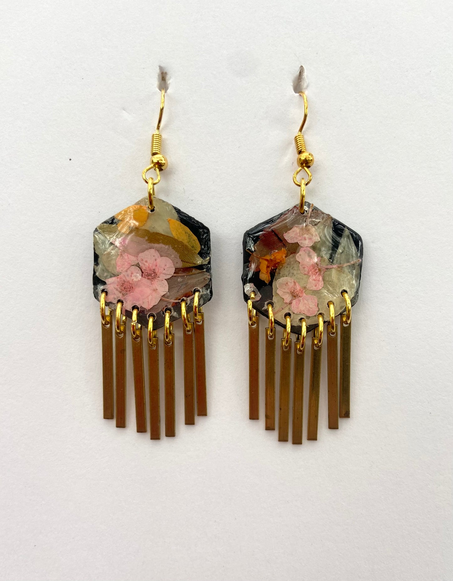 Hexagon floral polymer clay with brass fringe dangle hardware.