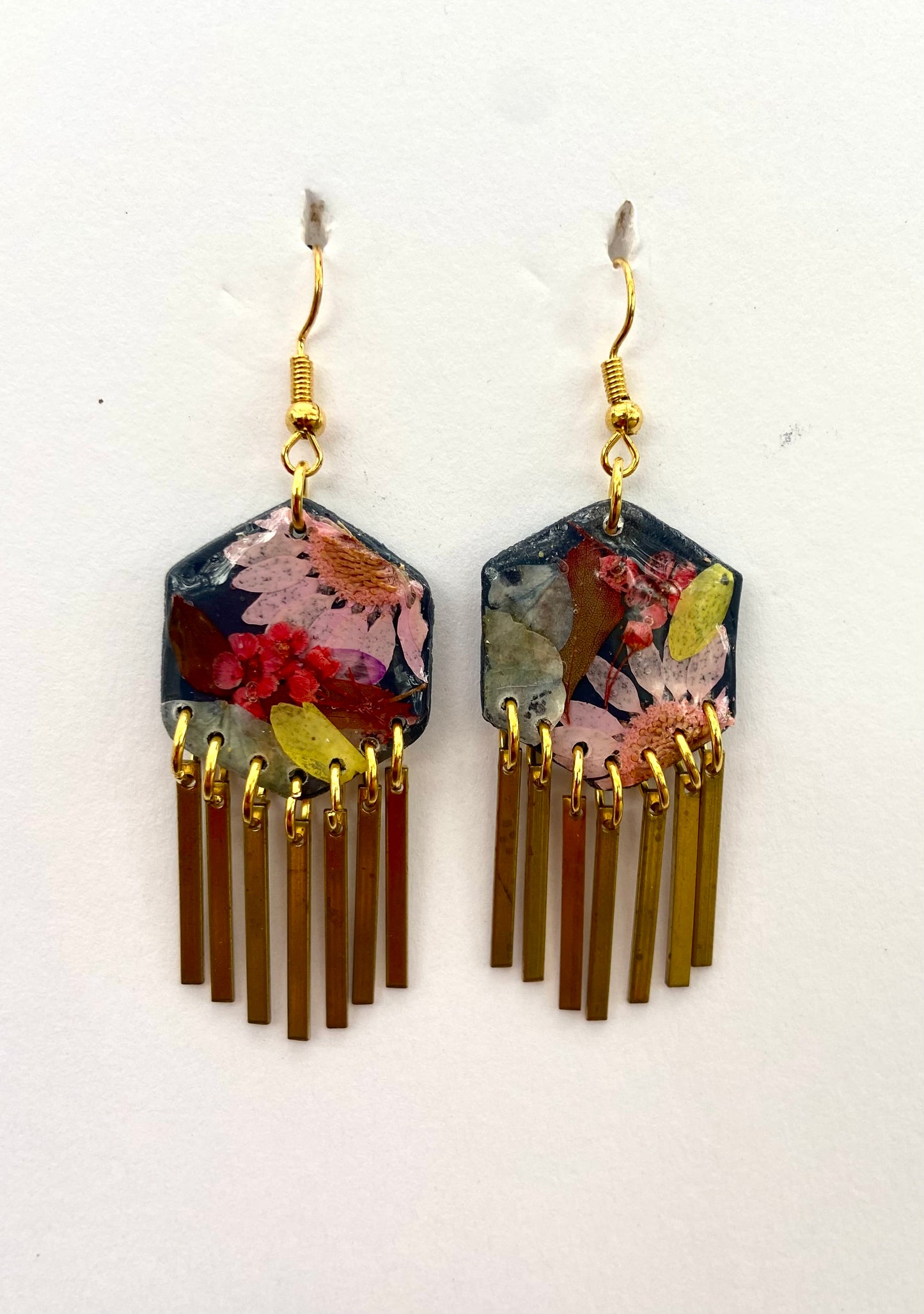 Hexagon floral polymer clay with brass fringe dangle hardware.