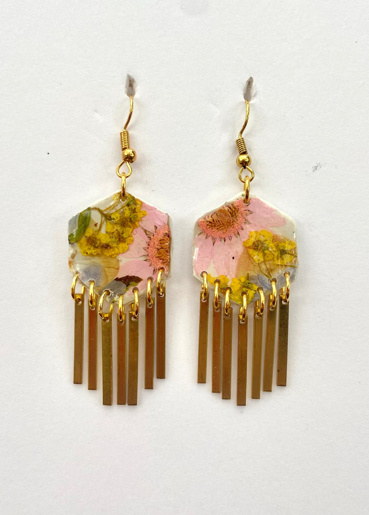 Hexagon floral polymer clay with brass fringe dangle hardware.