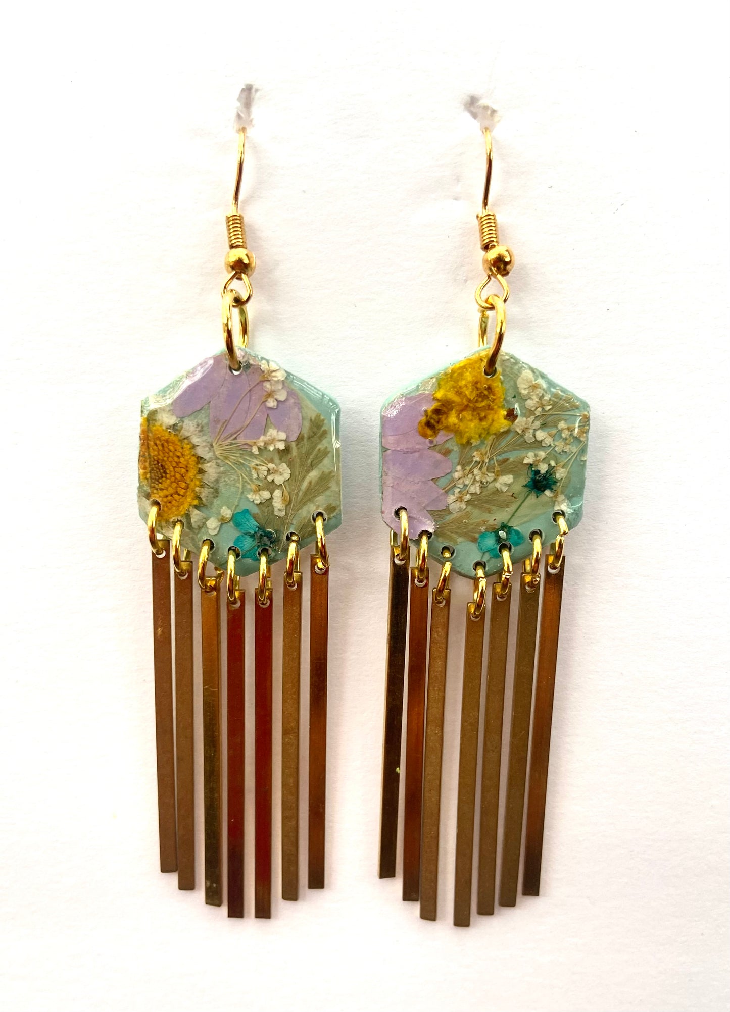 Hexagon floral polymer clay with brass fringe dangle hardware.