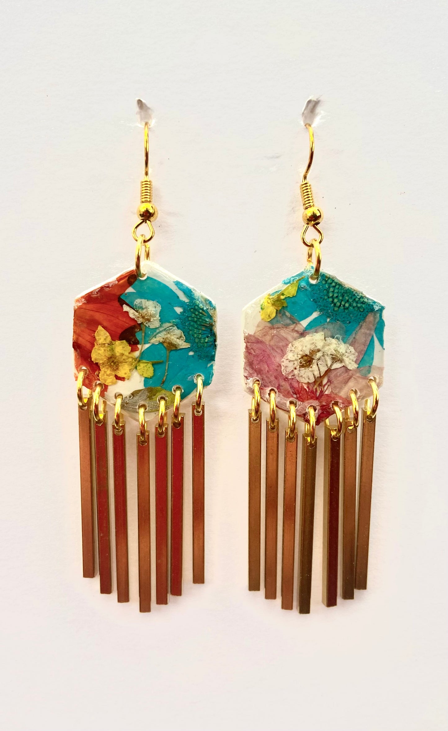 Hexagon floral polymer clay with brass fringe dangle hardware.