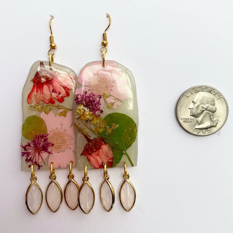 Floral earrings with gold accents on a white background